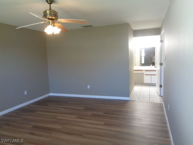 spare room featuring hardwood / wood-style floors and ceiling fan