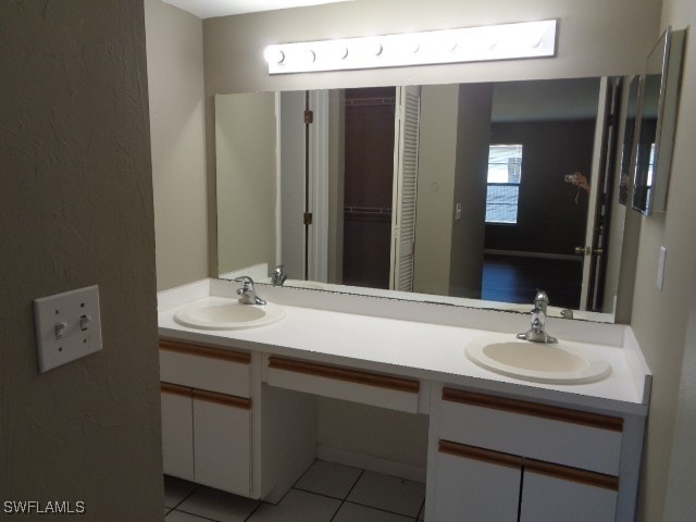 bathroom with tile patterned flooring and vanity