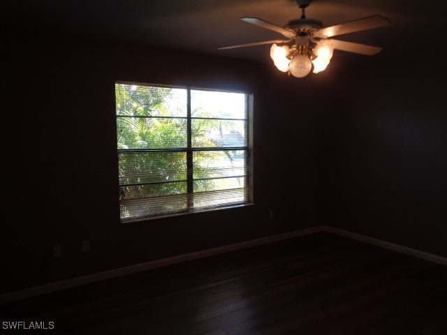 empty room with hardwood / wood-style flooring and ceiling fan