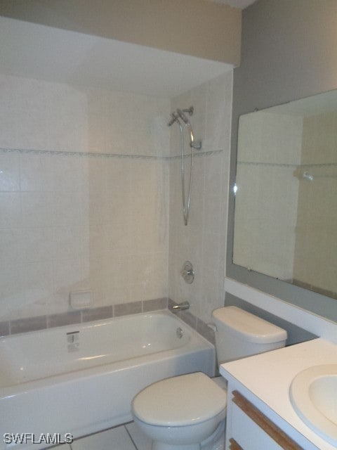 full bathroom featuring tiled shower / bath combo, toilet, and vanity