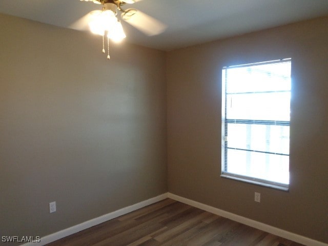 spare room with ceiling fan and dark hardwood / wood-style floors