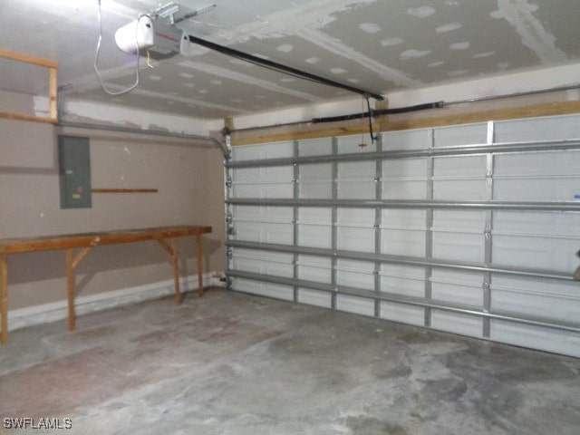 garage with electric panel and a garage door opener