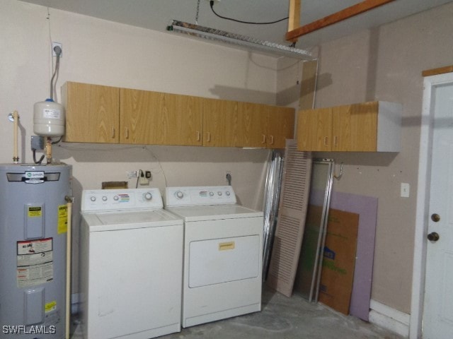 laundry area with washer and clothes dryer, cabinets, and water heater