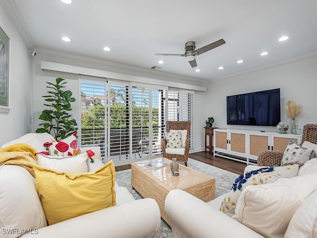 living room with hardwood / wood-style flooring, ceiling fan, and ornamental molding