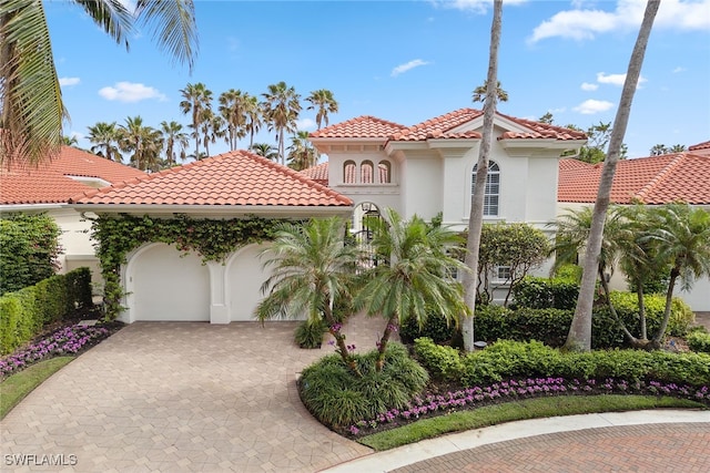 mediterranean / spanish house featuring a garage