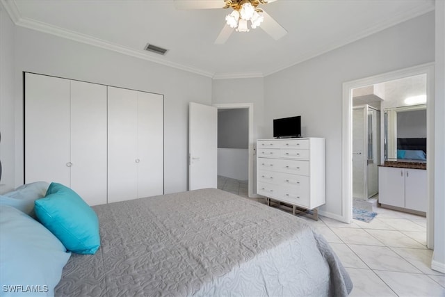 tiled bedroom featuring a closet, ceiling fan, and ornamental molding