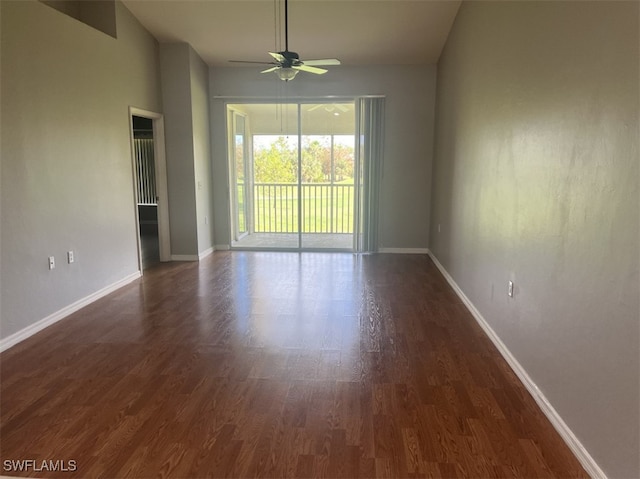 spare room with ceiling fan and dark wood-type flooring