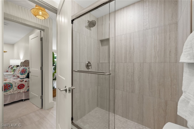 bathroom with tile patterned floors and a shower with shower door