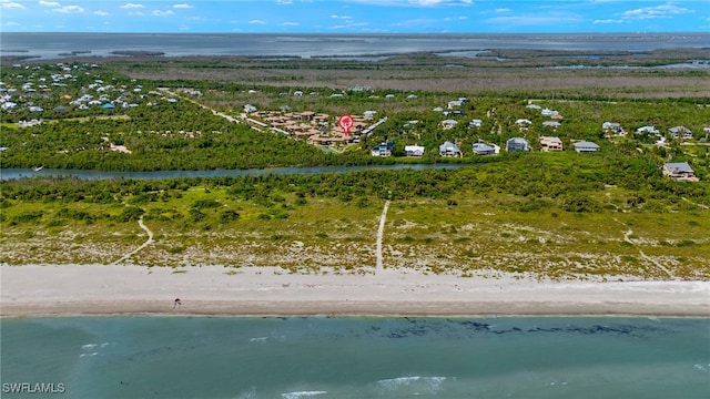 birds eye view of property featuring a water view and a beach view