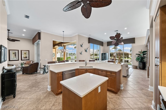 kitchen featuring stainless steel dishwasher, crown molding, sink, and an island with sink