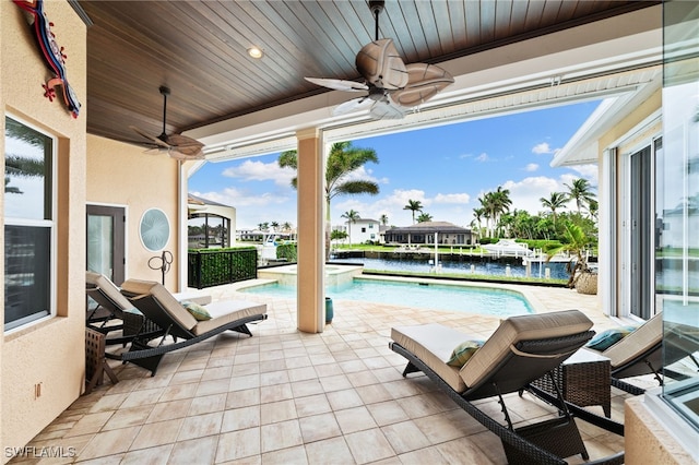 view of patio / terrace with ceiling fan and a water view