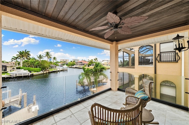 view of patio / terrace with ceiling fan and a water view