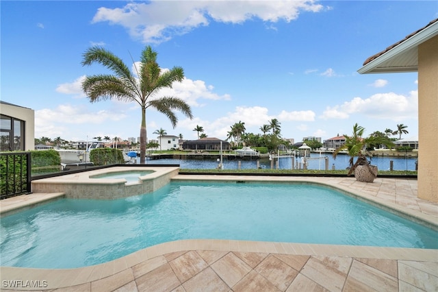 view of swimming pool with an in ground hot tub, a water view, and a patio