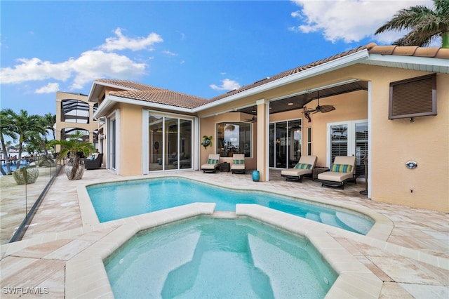 view of swimming pool with an in ground hot tub, a patio, and ceiling fan