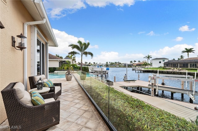 balcony with a boat dock and a water view