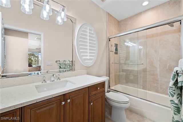 full bathroom featuring toilet, vanity, and combined bath / shower with glass door