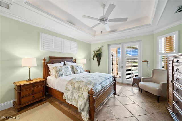 bedroom featuring access to exterior, a tray ceiling, ceiling fan, crown molding, and light tile patterned floors