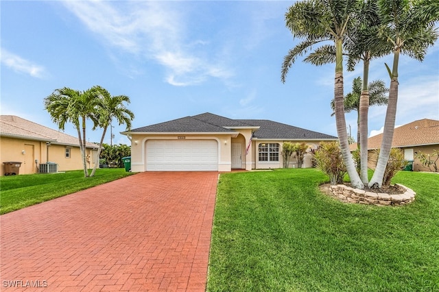 single story home with cooling unit, a garage, and a front yard