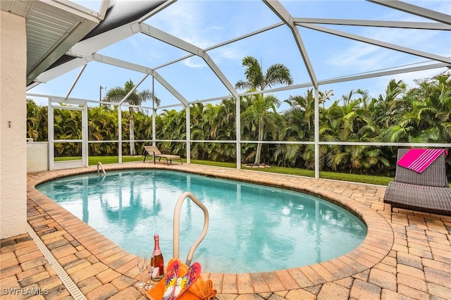 view of pool featuring a patio area and glass enclosure