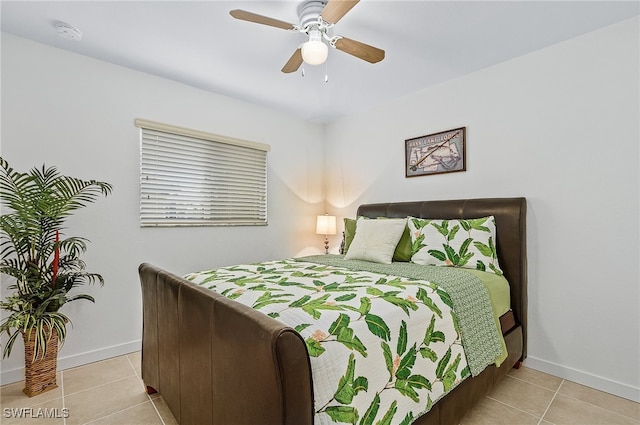 tiled bedroom featuring ceiling fan