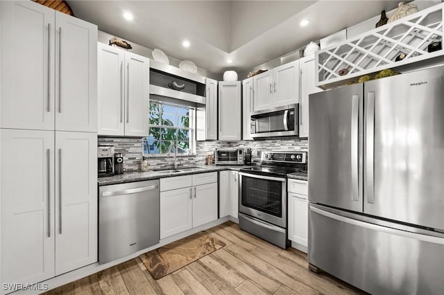 kitchen with white cabinetry, appliances with stainless steel finishes, and sink