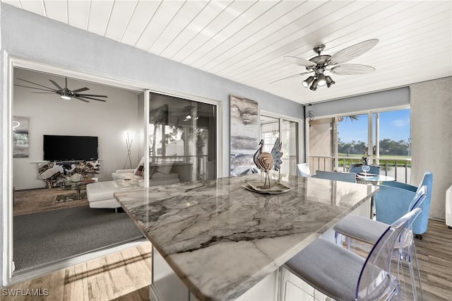 interior space featuring wooden ceiling and ceiling fan