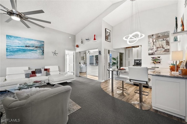 living room featuring high vaulted ceiling, hardwood / wood-style floors, a textured ceiling, and ceiling fan