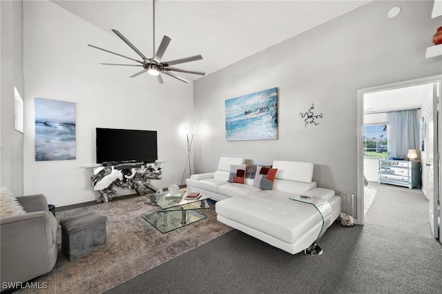 carpeted living room with high vaulted ceiling and ceiling fan