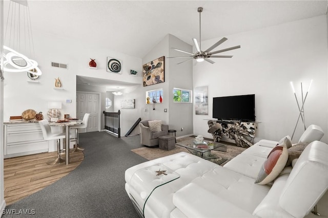 living room featuring hardwood / wood-style flooring, ceiling fan, and high vaulted ceiling