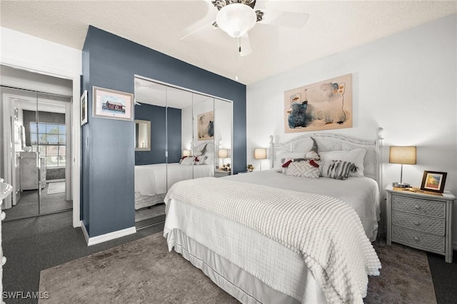 carpeted bedroom featuring ceiling fan and a closet