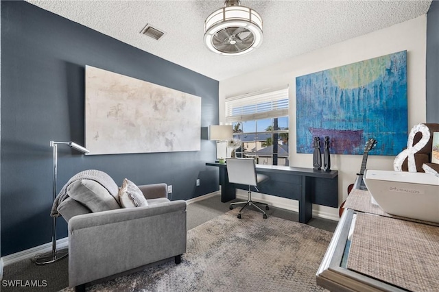 office space featuring carpet floors and a textured ceiling