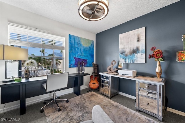 carpeted home office with a textured ceiling