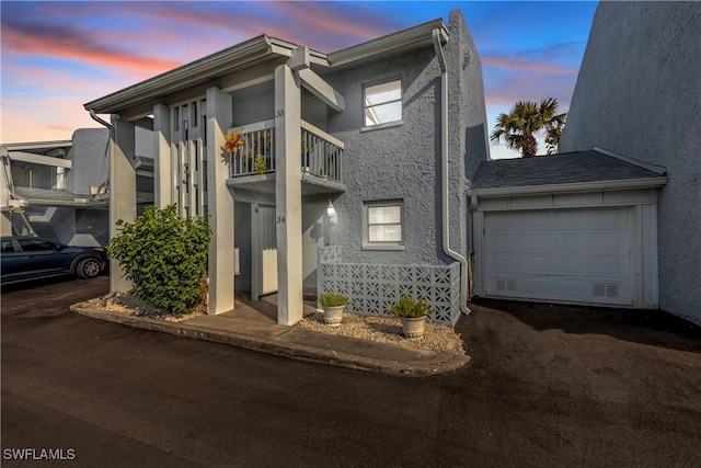 view of front of home with a balcony and a garage