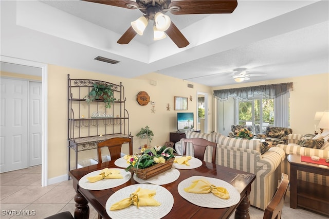 34 Watercolor Way Unit 34, Naples, FL 34113 - dining area with ceiling fan, light tile patterned floors, a tray ceiling, and baseboards