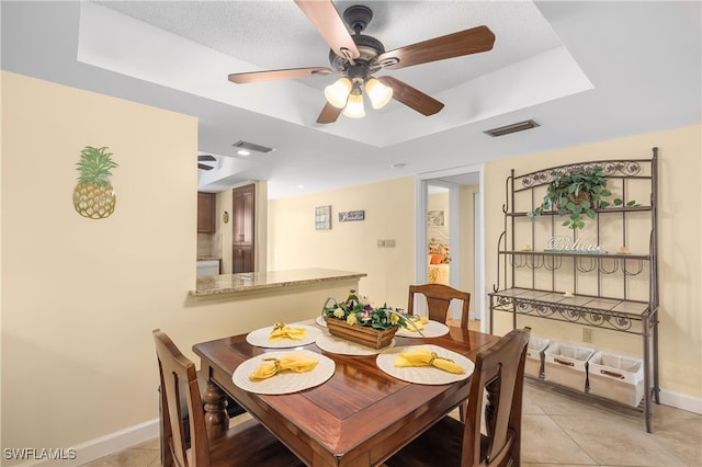 34 Watercolor Way Unit 34, Naples, FL 34113 - dining area featuring a tray ceiling, a ceiling fan, baseboards, and light tile patterned floors