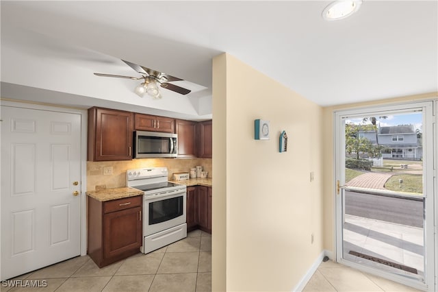 kitchen with light stone countertops, backsplash, ceiling fan, light tile patterned floors, and white range with electric cooktop