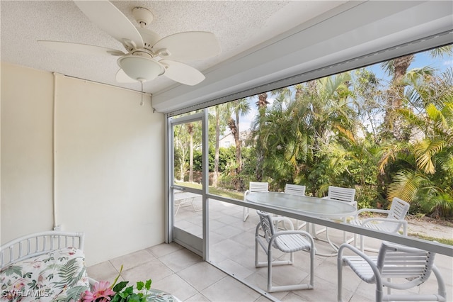 sunroom featuring ceiling fan