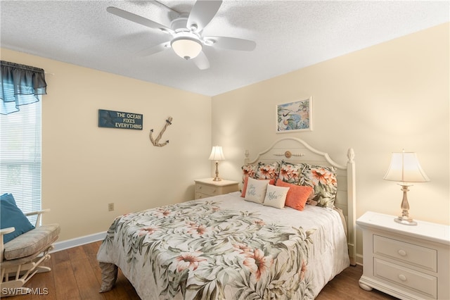 bedroom featuring ceiling fan, dark hardwood / wood-style floors, and a textured ceiling