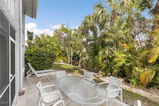 34 Watercolor Way Unit 34, Naples, FL 34113 - view of patio featuring outdoor dining area and view of scattered trees