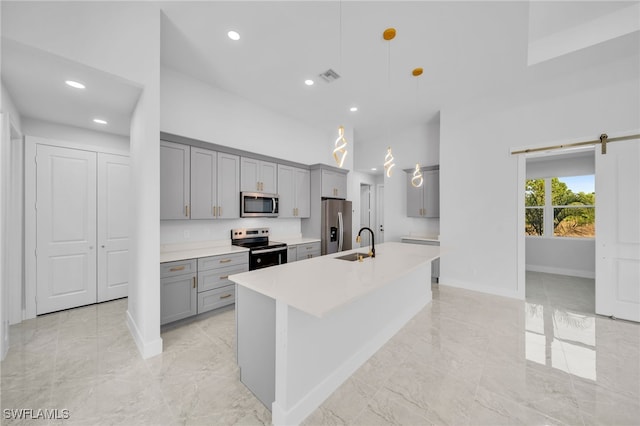 kitchen with gray cabinetry, sink, hanging light fixtures, and appliances with stainless steel finishes