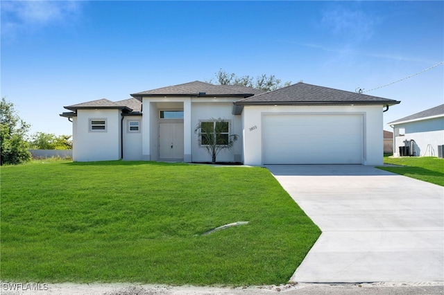 view of front of home with a garage and a front lawn