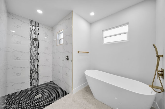 bathroom featuring shower with separate bathtub