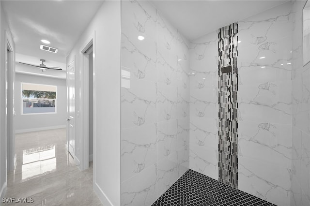 bathroom featuring ceiling fan and a tile shower