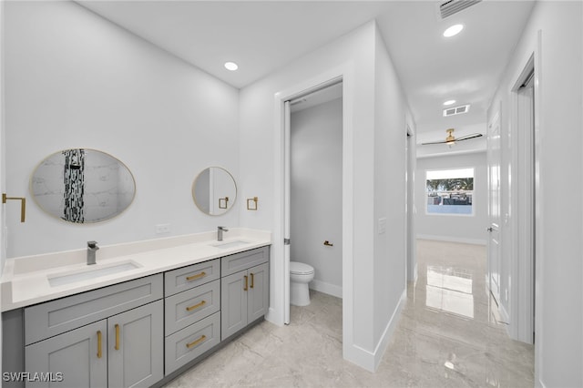 bathroom with ceiling fan, vanity, and toilet