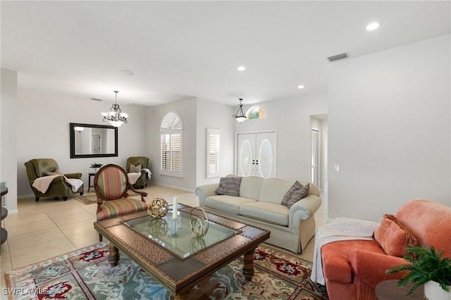 tiled living room with a chandelier