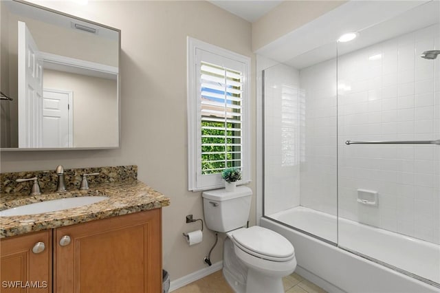 full bathroom with tile patterned flooring, bath / shower combo with glass door, vanity, and toilet