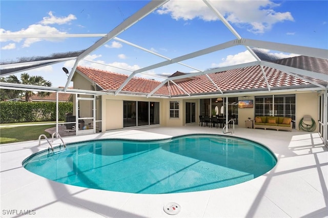 view of pool with a lanai and a patio area