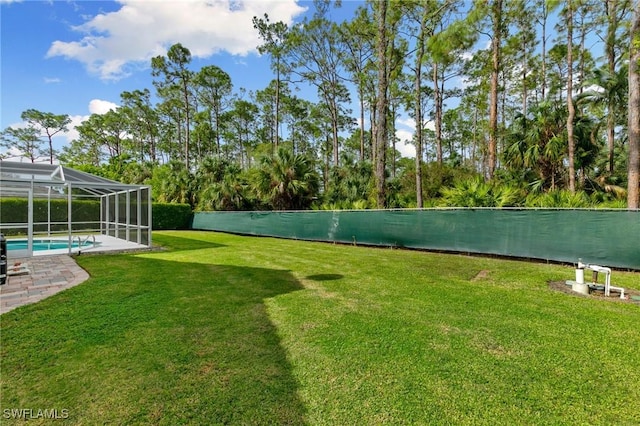 view of yard featuring a fenced in pool and a lanai