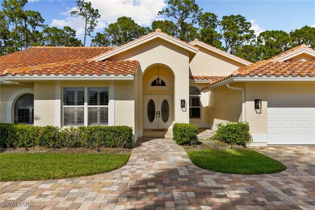 mediterranean / spanish-style home featuring a garage