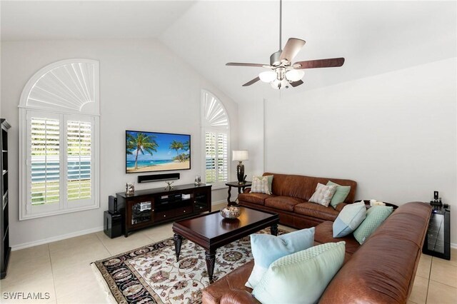 living room with plenty of natural light, light tile patterned floors, and lofted ceiling